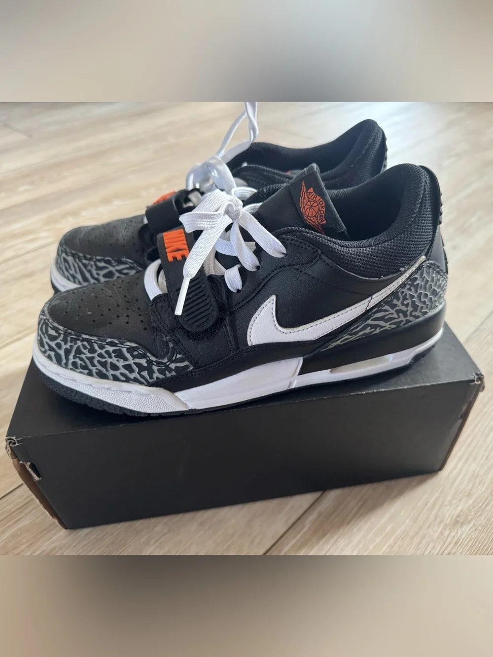 Nike Men’s Black and White Sneakers with Orange Logo Accent